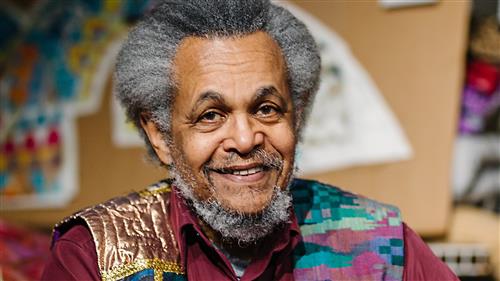portrait of a man wearing a colorful vest
